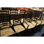 A HARLEQUIN SET OF 12 OAK WICKER SEAT CHAIRS