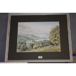 A FRAMED AND GLAZED WATERCOLOUR DEPICTING A MOUNTAINOUS LANDSCAPE BY NEIL TAYLOR