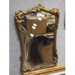 A VINTAGE GILT FRAMED WALL MIRROR