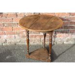 AN ANTIQUE OAK PROVINCIAL CRICKET TABLE, the typical circular tope supported on three turned legs, H