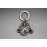 A HALLMARKED SILVER NOVELTY BABY RATTLE IN THE FORM OF HUMPTY DUMPTY - BIRMINGHAM 1909, with bells