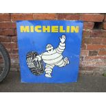 A VINTAGE MICHELIN ALUMINIUM ADVERTISING SIGN DEPICTING MR. BIBENDUM ROLLING A TYRE, single sided,