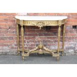 AN ANTIQUE GILTWOOD AND MARBLE TOPPED CONSOLE TABLE, the shaped marble top above a carved base