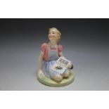 AN ALICE IN WONDERLAND FIGURE, thought to be a Royal Doulton prototype showing a seated girl in
