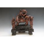 A CARVED HARDWOOD CHINESE FIGURE OF A MAN RIDING AN ELEPHANT, on a plinth with a scholar standing