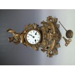 A FRENCH GILT CAST METAL DECORATIVE MANTLE CLOCK, the circular enamel dial with Roman numerals and