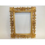 A 20TH CENTURY OVAL CARVED WOODEN DECORATIVE GILT FRAME, rebate 24 x 18 cm, overall H 43 cm, W 30 cm