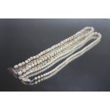 A PEARL NECKLACE WITH DIAMOND ENCRUSTED CATCH, L 46 cm together with a smaller example on 9 carat