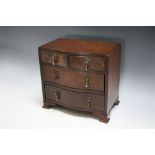 A MINIATURE SERPENTINE CHEST OF DRAWS, W 20.25 cm