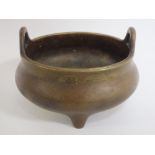AN ORIENTAL BRONZE TYPE TWIN HANDLED CENSOR, with six character mark to base, Dia. 14 cm