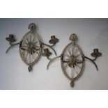 A PAIR OF REGENCY GILT METAL TWIN BRANCH WALL SCONCES, the openwork frame having cut glass starburst