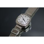 A HALLMARKED 18 CARAT WHITE GOLD AND DIAMOND LADIES RWC CO LTD WRIST WATCH, probably that of The