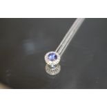 A PLATINUM SAPPHIRE AND DIAMOND PENDANT, set on a 925 silver chain, Dia. 11 mm