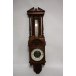 AN EDWARDIAN OAK CARVED ANEROID BAROMETER, H 103 cm