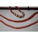 A GRADUATED SINGLE STRAND CORAL BEAD NECKLACE, approx L 41 cm, together with another single strand