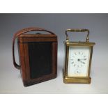 AN EARLY 20TH CENTURY BRASS CASED REPEATER ALARM CARRIAGE CLOCK WITH FITTED LEATHER CARRY CASE,