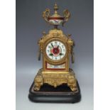 A LATE 19TH CENTURY CONTINENTAL PORCELAIN AND GILT SPELTER CLOCK, the case surmounted with twin