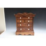 A PITCH PINE MINIATURE CHEST OF DRAWS, H 46 cm