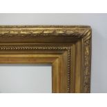 A 19TH CENTURY GOLD FRAME WITH ACANTHUS LEAF DECORATION AND SHOT SITE EDGE, frame W 9 cm, slip