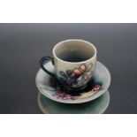 A SMALL MOORCROFT CUP AND SAUCER, Dia 10.75 cm