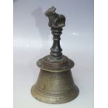 A LATE 19TH / EARLY 20TH CENTURY BRONZE AND BRASS TEMPLE BELL, with resting bull on top of the