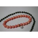 A SINGLE STRAND OF HAND KNOTTED SPINACH JADE BEADS, overall L 44 cm, together with a dyed bone