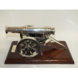 A LARGE SILVER PLATED BRONZE DESK CANNON, mounted on a mahogany plinth with plaque 'Eighteen Pounder