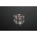 A HALLMARKED 9 CARAT WHITE GOLD AND FIVE STONE TANZANITE RING, approx weight 4g, ring size O