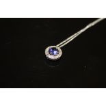 A PLATINUM SAPPHIRE AND DIAMOND PENDANT, set on a 925 silver chain, Dia. 11 mm