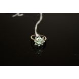 AN 18 CARAT WHITE GOLD GEM SET RING, in a floral style with light green stones, approx weight 4g,