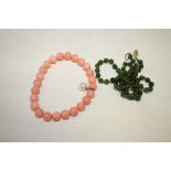 A SINGLE STRAND OF HAND KNOTTED SPINACH JADE BEADS, overall L 44 cm, together with a dyed bone