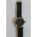 W.W.W. WWII "RECORD" MILITARY WRIST WATCH, with black dial and engraved case markings
