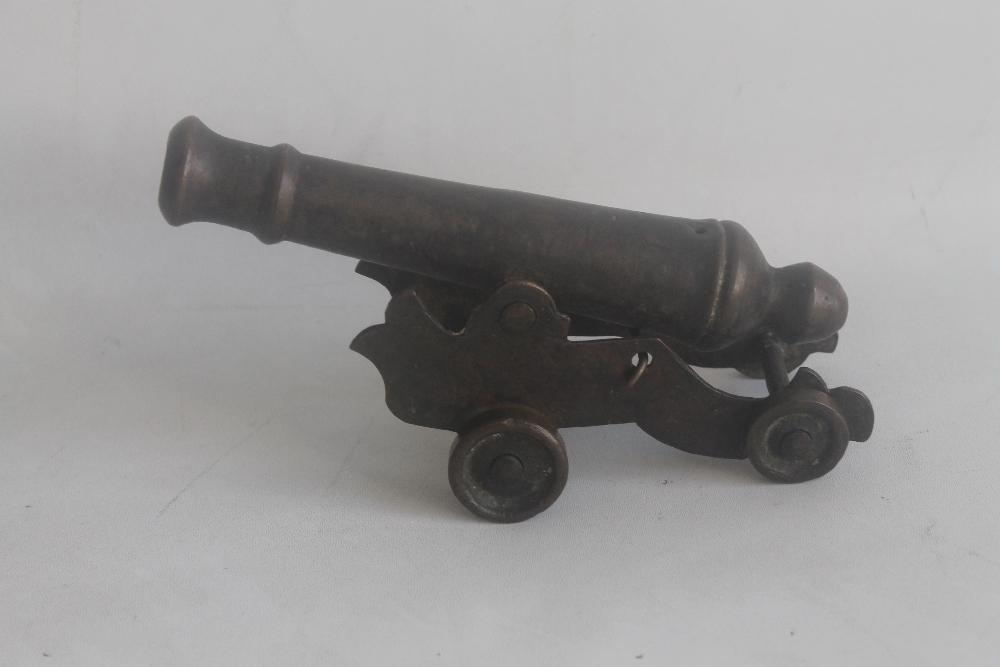 A BRONZE SIGNAL CANNON OF EARLY 18TH CENTURY TYPE, mounted on sheet brass carriage overall length of