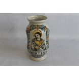 A CONTINENTAL ALBARELLO TYPE GLAZED PHARMACY JAR, decorated with a saint and the legend "O