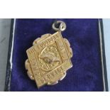FOOTBALL INTEREST- A 15 CT GOLD "FOOTBALL LEAGUE LONG SERVICE" MEDAL IN CASE, engraved to back "F.