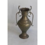 AN ANGLO INDIAN BRASS VASE WITH COBRA HANDLES, the body decorated all over with wild animals in