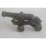 A SMALL BRONZE SIGNAL CANNON WITH DECORATED BARREL, mounted on sheet brass carriage cannon length