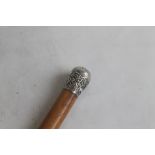 A LATE 19TH CENTURY ANGLO INDIAN WALKING CANE, with foliate decorated white metal cap