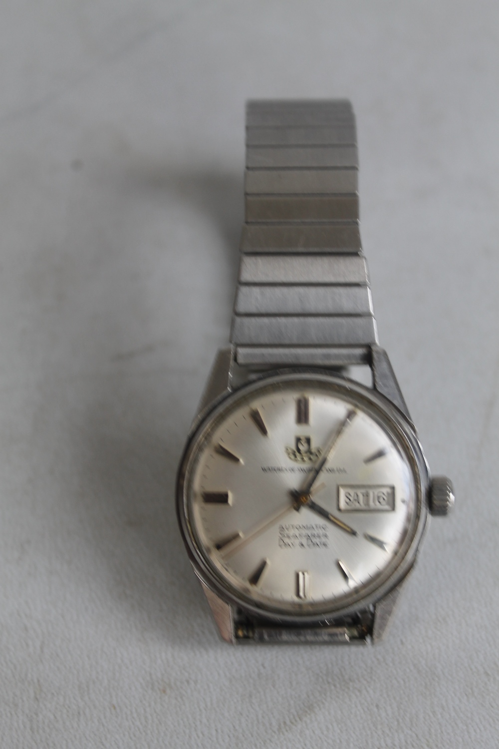 A VINTAGE "WATCHES OF SWITZERLAND" AUTOMATIC SEAFARER DAY DATE, gentleman's stainless steel wrist