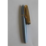A "PARKER 100" FOUNTAIN PEN, powder blue barrel with gold plated cap
