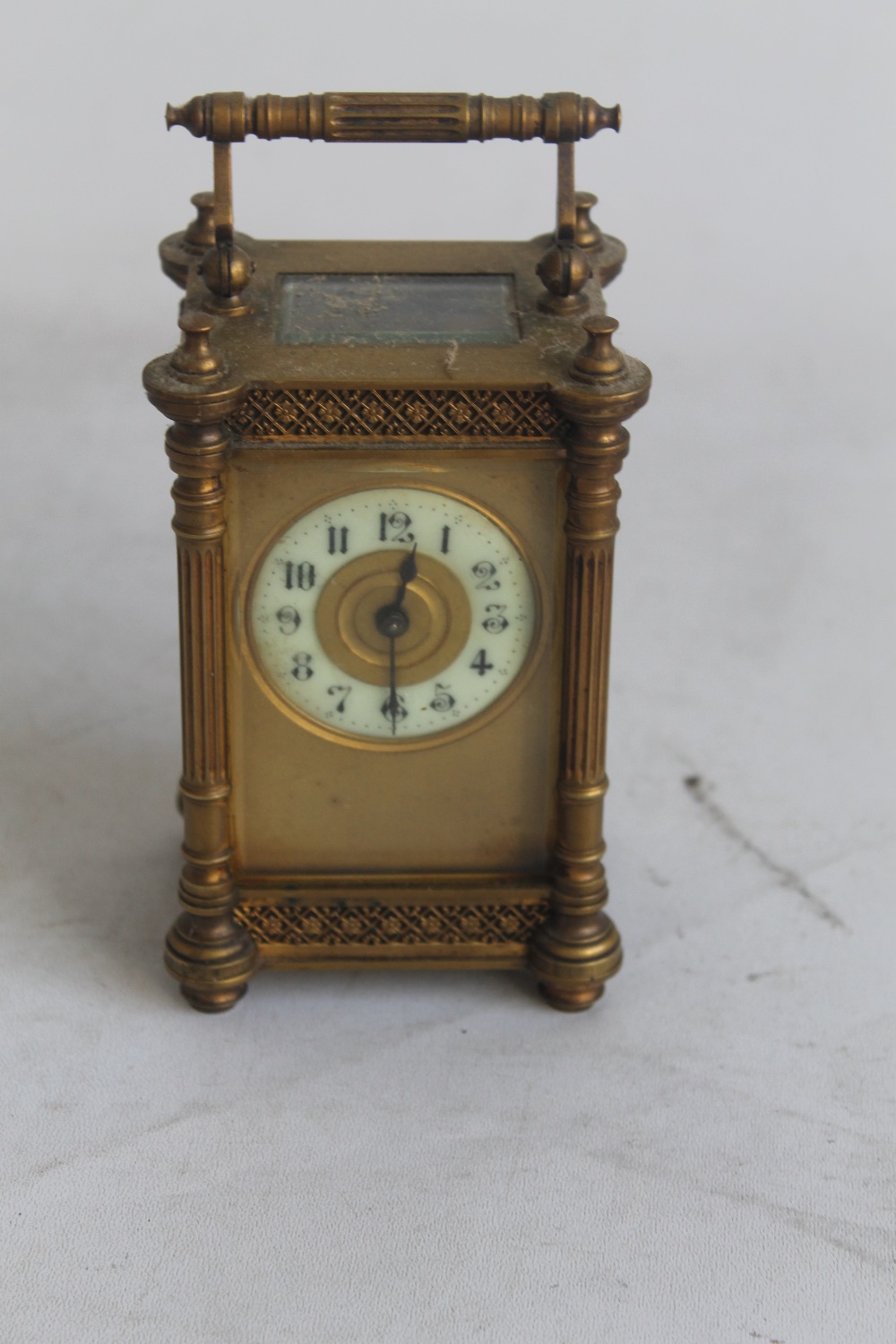 AN ANTIQUE GILT METAL CASED CONTINENTAL CARRIAGE CLOCK