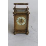 AN ANTIQUE GILT METAL CASED CONTINENTAL CARRIAGE CLOCK