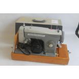 A FRISTER AND ROSSMAN ELECTRIC SEWING MACHINE IN CARRY CASE