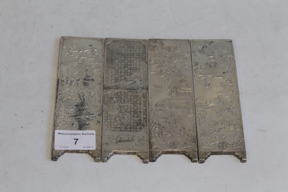 FOUR CHINESE WHITE METAL INGOT PLAQUES, decorated with various scenes 14.5 cm x 4.5 cm