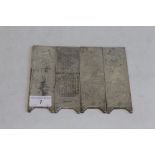 FOUR CHINESE WHITE METAL INGOT PLAQUES, decorated with various scenes 14.5 cm x 4.5 cm