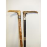 A HALLMARKED SILVER BANDED RIDING CROP, together with a similar example, L 69 cm (2)