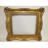 A 19TH CENTURY DECORATIVE GOLD SWEPT FRAME, with gilt slip, frame W 11 cm, slip rebate 62 x 52 cm,