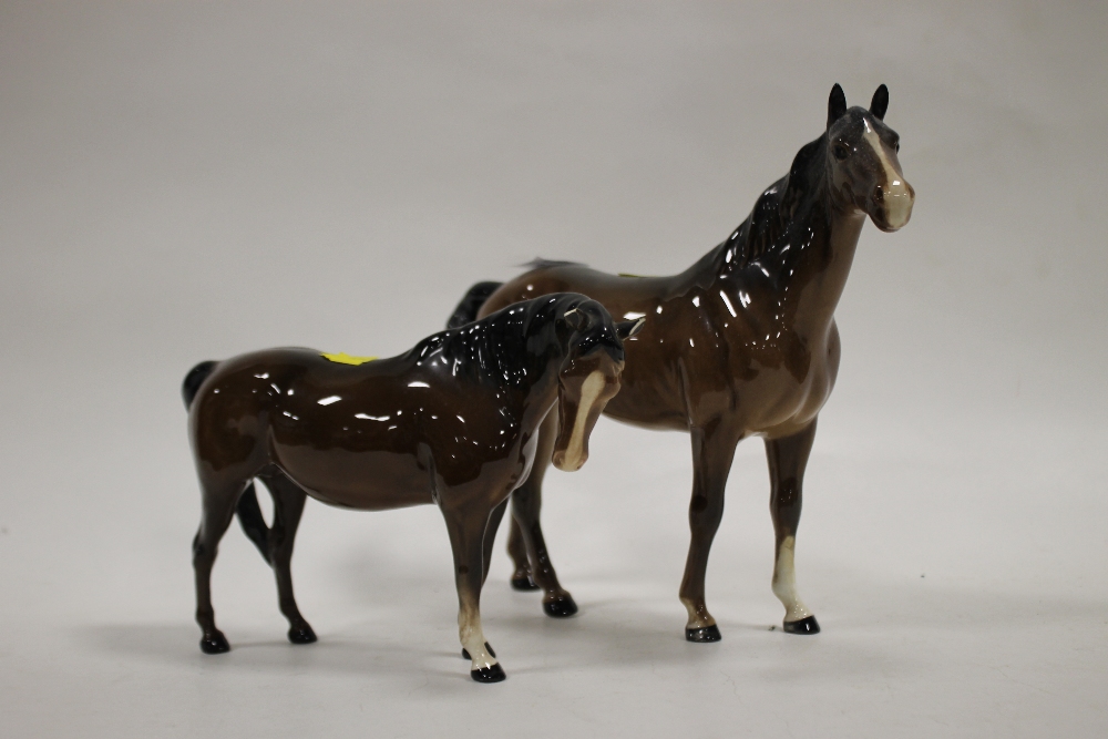 A BESWICK RIGHT FACING SWISH TAILED HORSE TOGETHER WITH ANOTHER A/F