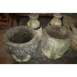 A PAIR OF STONE PLANTERS ON PLINTHS