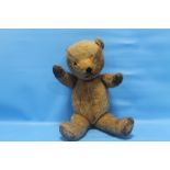 A VINTAGE STRAW FILLED TEDDY BEAR (IN NEED OF TLC)